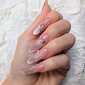 Hand with decorative nails on a white lace background